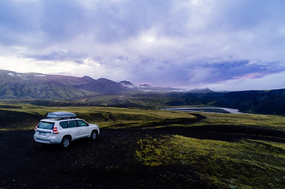 Iceland Mountains and Valley with White Toyota Rental Overlooking the Valley