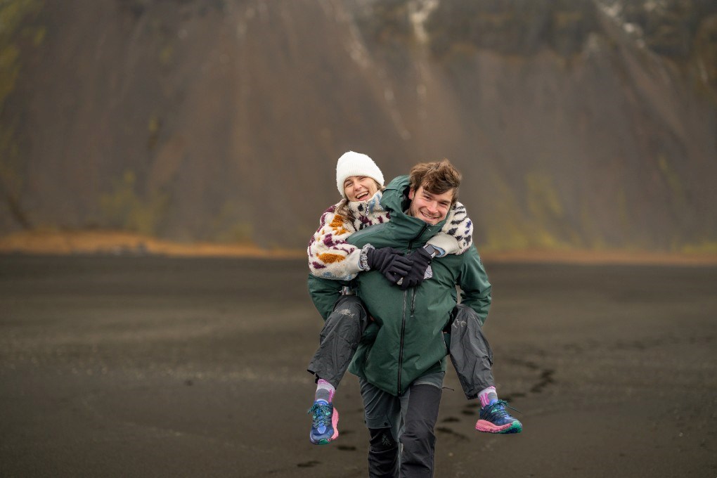 Happy travellers doing a road trip in Iceland with a rental car