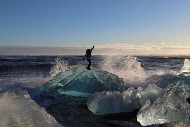 Man Standing on Glacier in Jöklulsárlón Glacier Lagoon