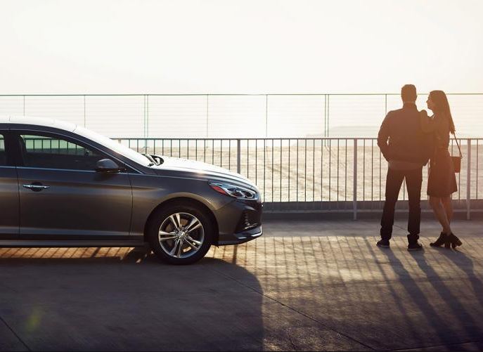 Couple Standing near fence and car