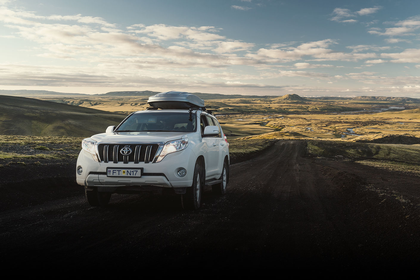 White Toyota Rental SUV Driving up an Icelandic Dirt Road