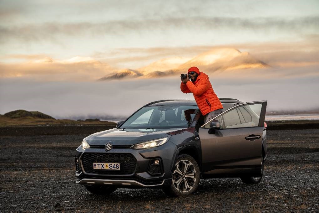 Photographer travelling by car in Iceland