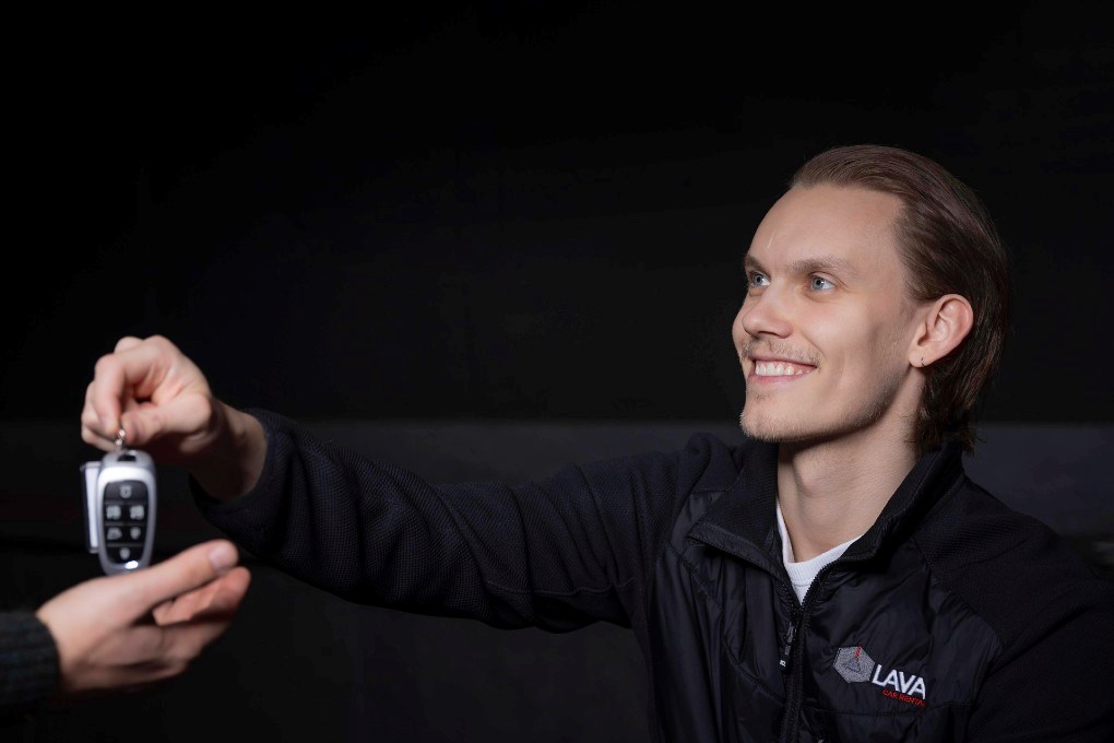 Lava Car Rental employee giving key to customer Lava Car Rental employee giving key to customer