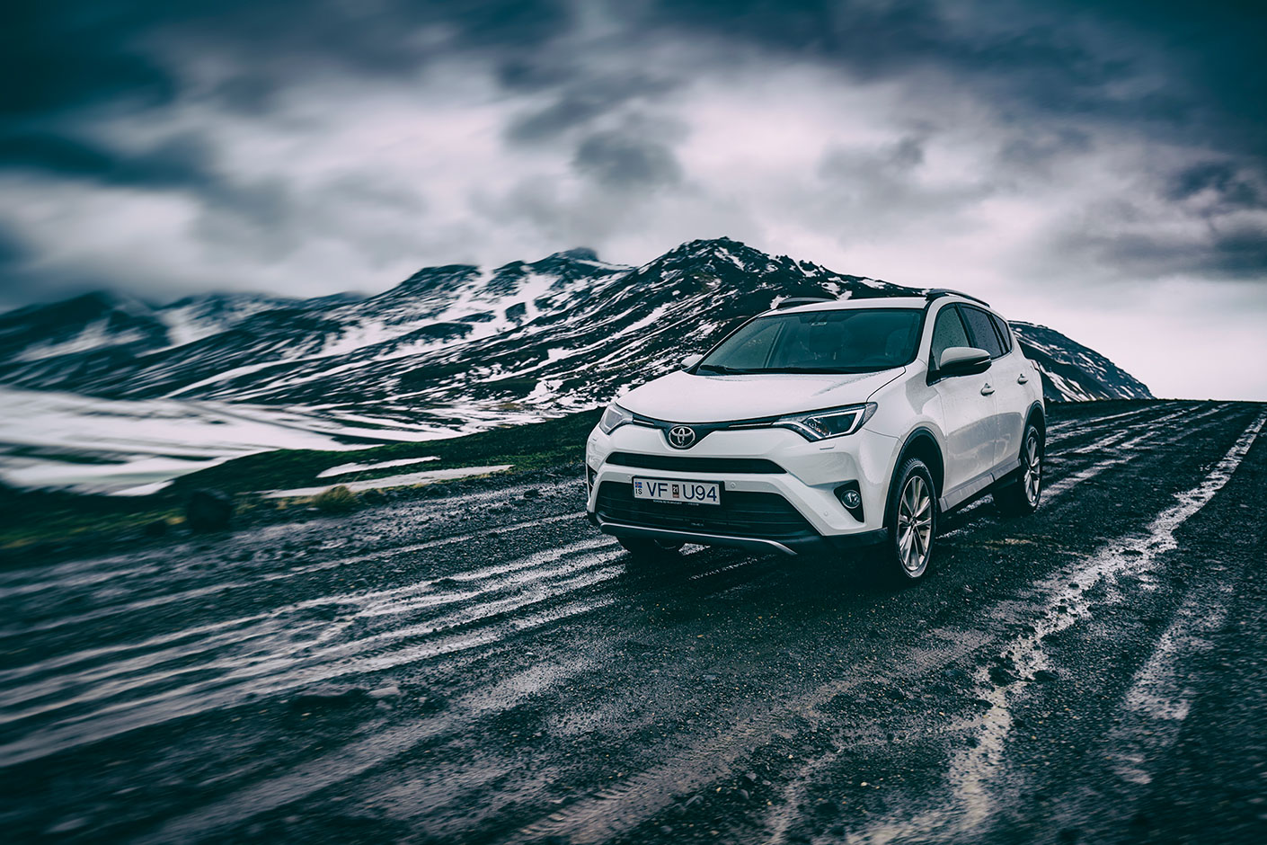 Toyota SUV driving on Icelandic Dirt Road over Mountain