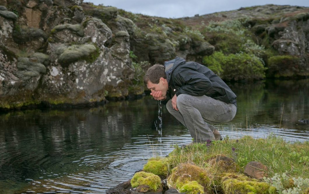 Man drinking water from Icelandic Spring