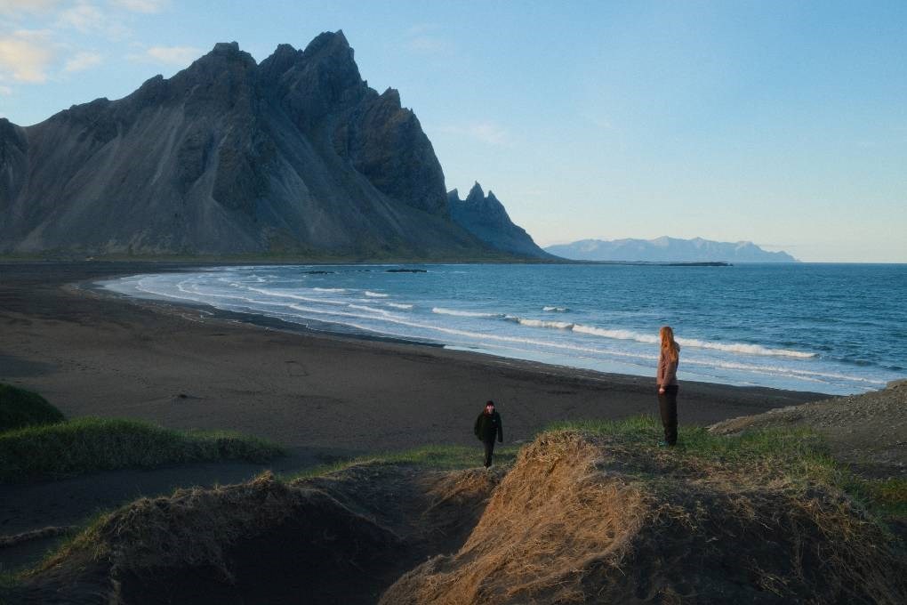 Travellers exploring Vestrahorn, in Iceland Travellers exploring Vestrahorn, in Iceland